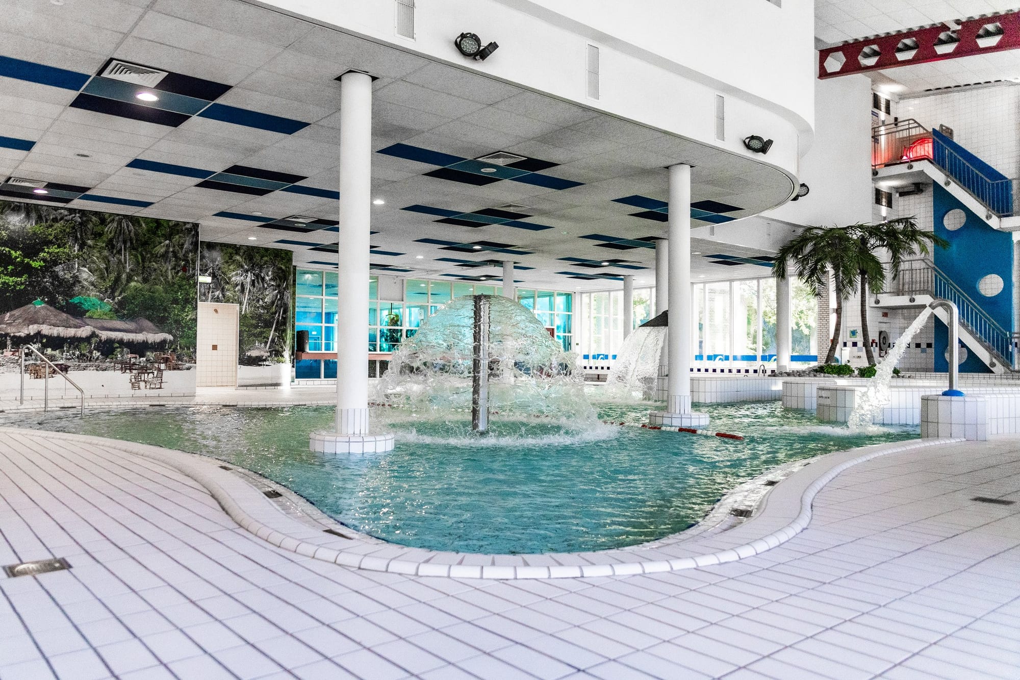 Het recreatiebad met palmen en fontein in het Inge de Bruijn Zwembad